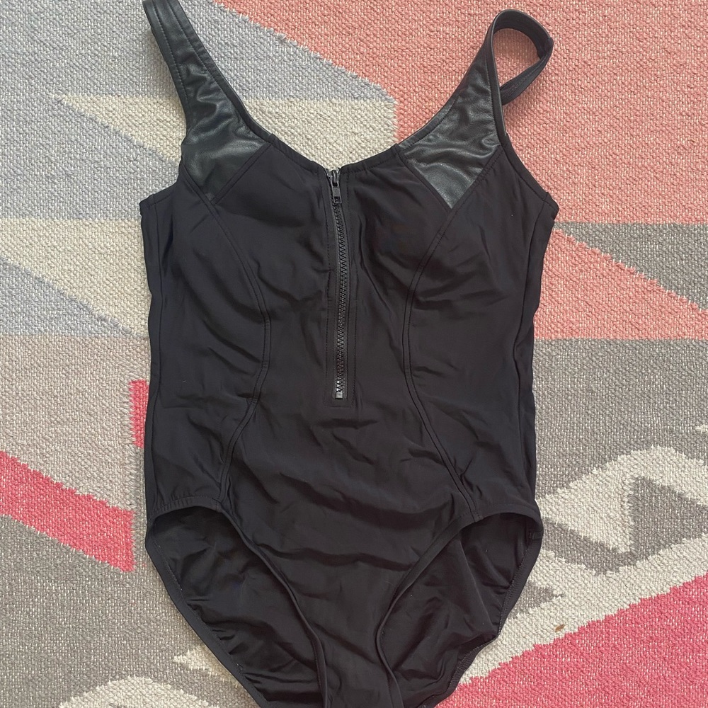 Chic black one piece with faux leather detail